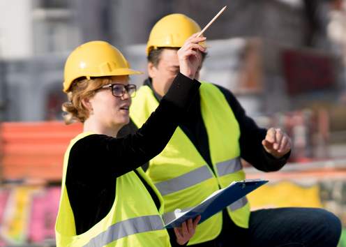 Two Construction Registered Apprentices working together on a project in a warehouse