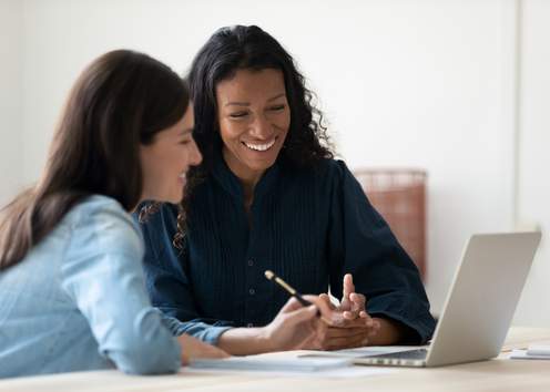 Two Registered Apprenticeship Program Sponsors discussing and working together at a laptop